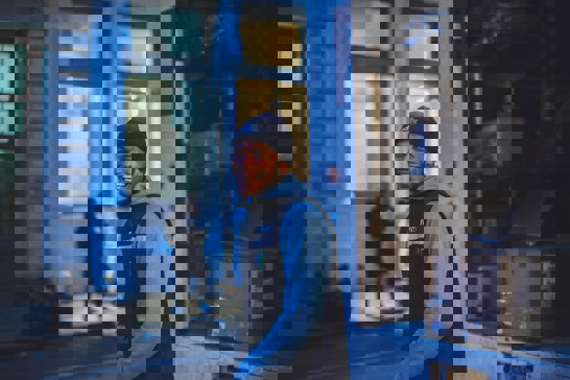 Delivery driver smiling next to his truck