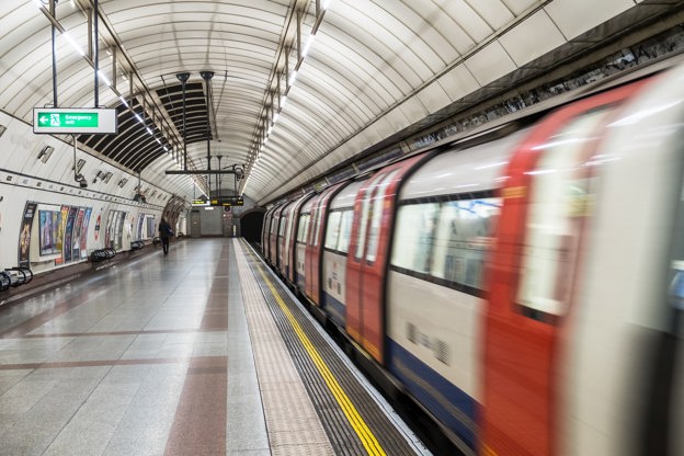 London underground platform with train moving nearby