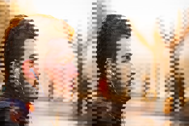 Male with earphones in