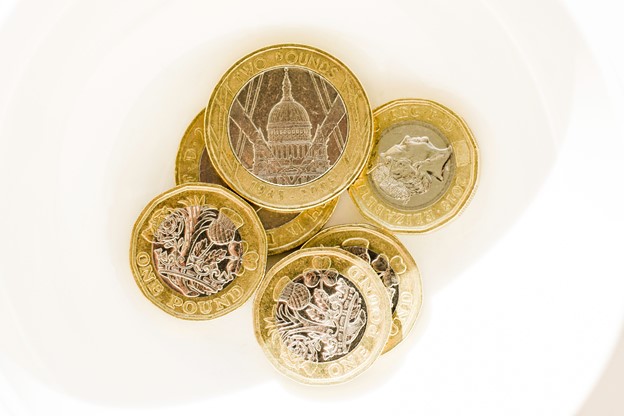 Six English sterling coins displayed on white background