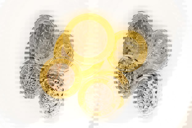 Six English sterling coins displayed on white background