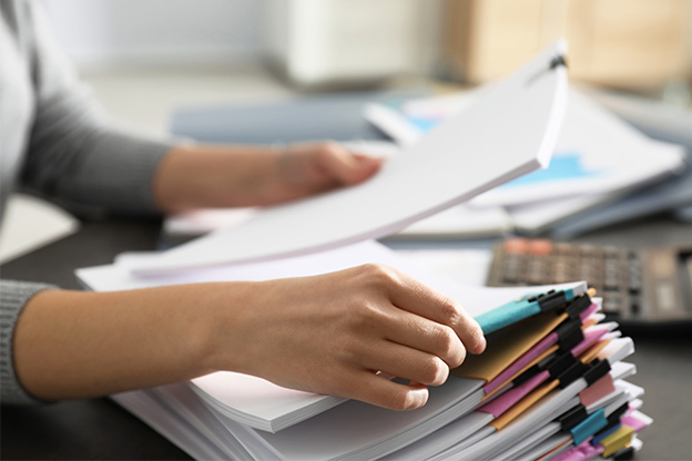 Woman sorting through a stack of documents