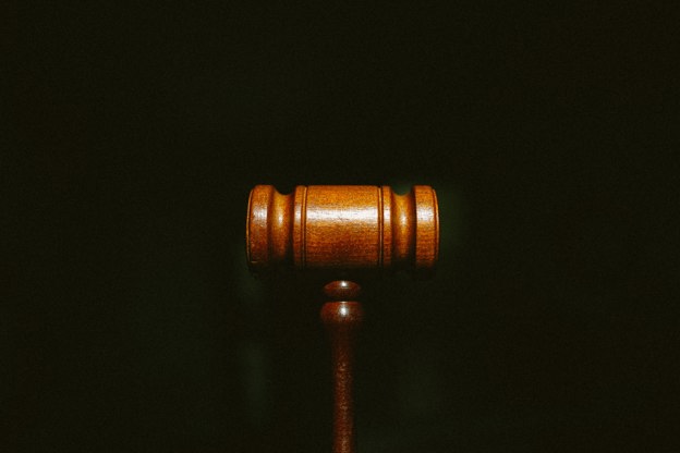 Brown gavel displayed on a black background