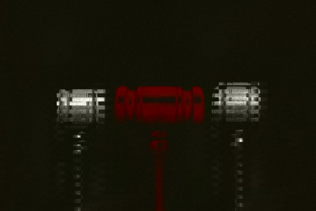 Brown gavel displayed on a black background