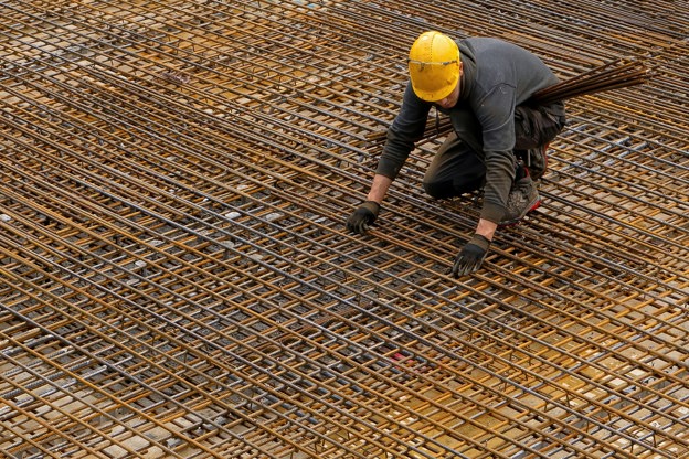 Construction worker on site working with pipes