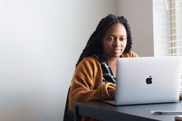 Woman sat at a desk, on her laptop