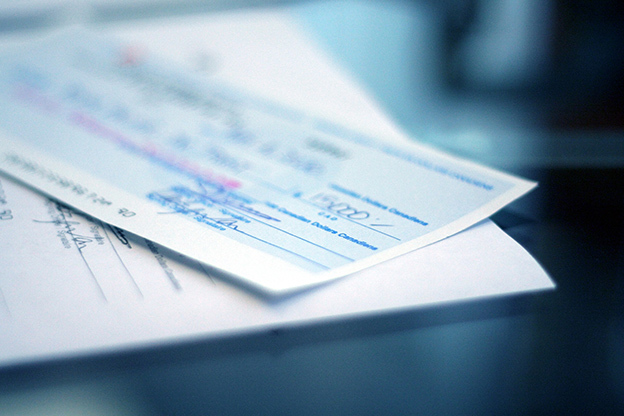 Cheque displayed on top of some paperwork